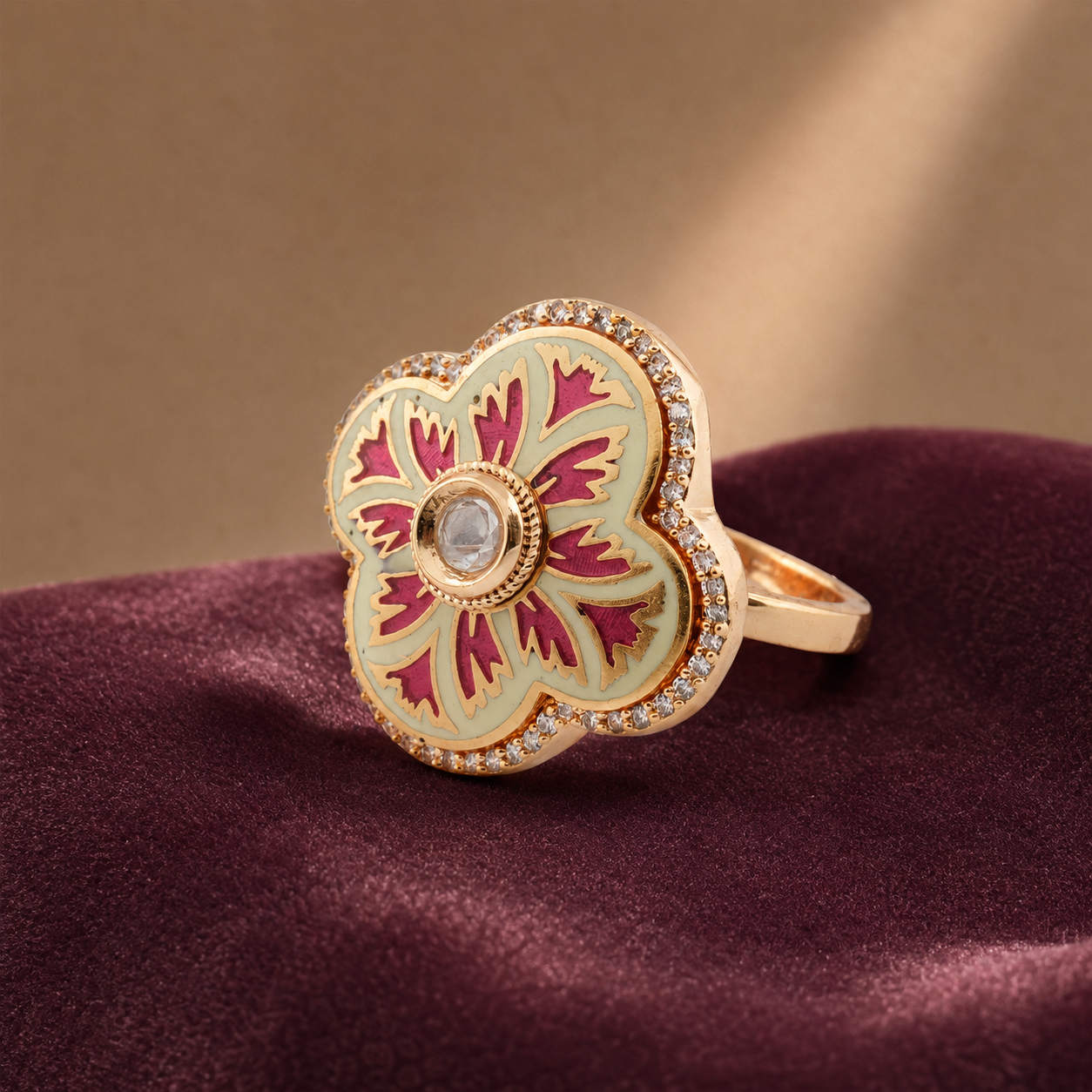Pink and ivory floral statement ring displayed on burgundy fabric