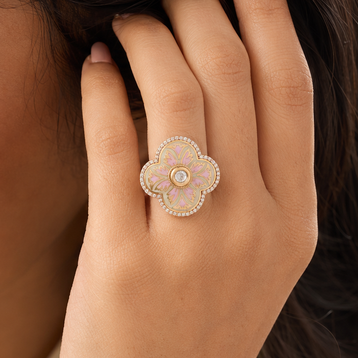 Woman wearing a pink enamel-look floral statement ring