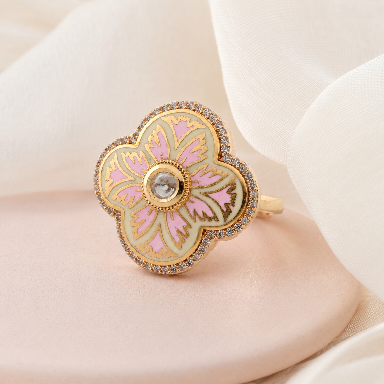 Blush-pink floral statement ring displayed on a soft luxury background