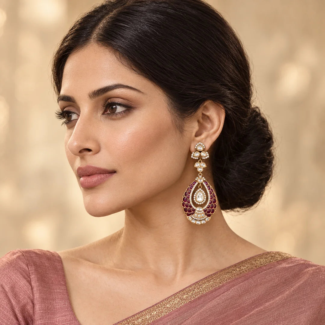 Indian model in a dusty-rose saree wearing a Mayura wine teardrop earring with scalloped detailing and clear stones.
