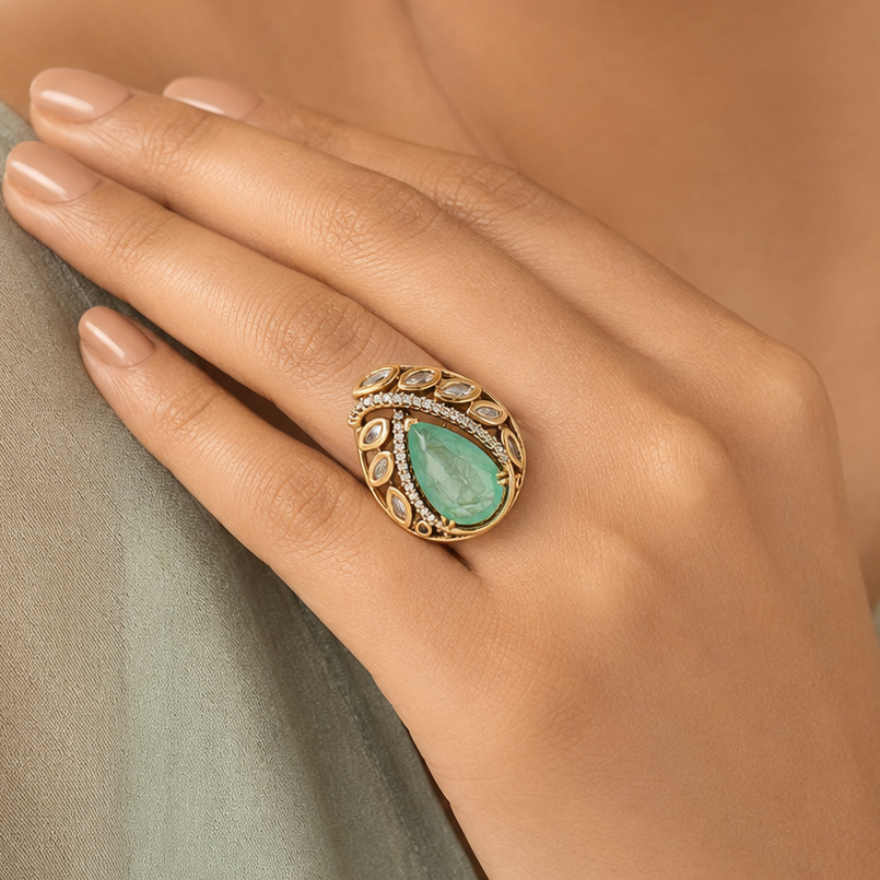 Woman wearing a mint-green Kundan-look statement finger ring by Zoi Craft