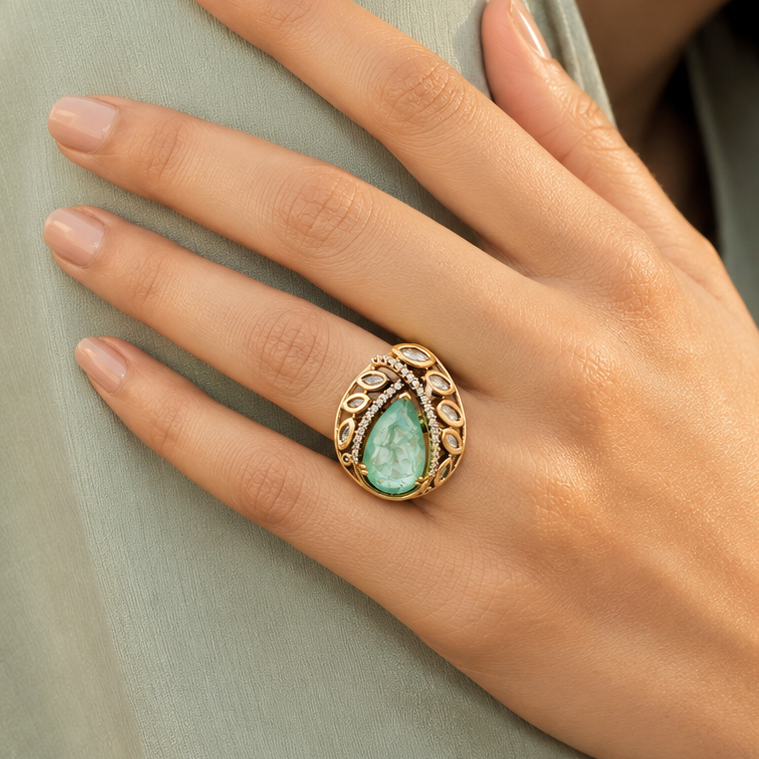 Meher green statement ring presented in a styled lifestyle setting