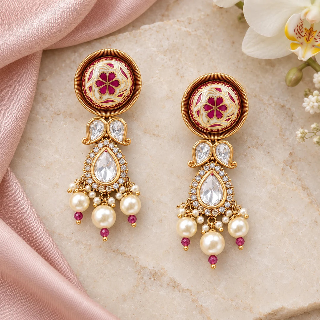 Pair of Mrinalini pink and ivory floral earrings with gold-tone borders, clear teardrop stones and cream pearl-style drops.