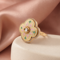 Pastel floral statement ring displayed on a neutral pedestal