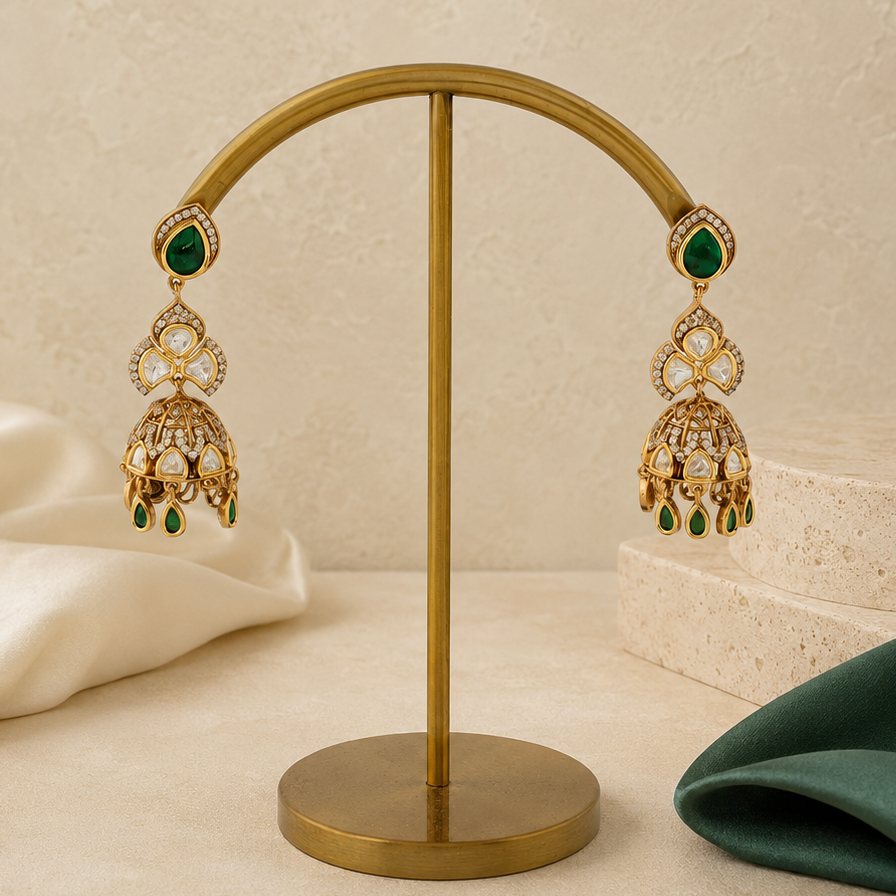 Nayra gold polki-look floral jhumka earrings styled with ivory and emerald-green props