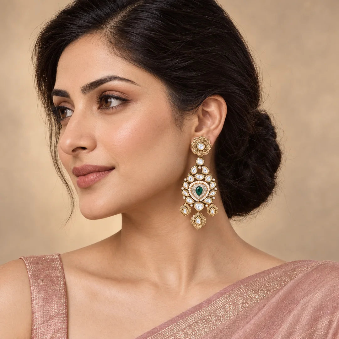 Indian model in a blush saree wearing a Padmika green statement earring with a floral stud and three engraved drops.