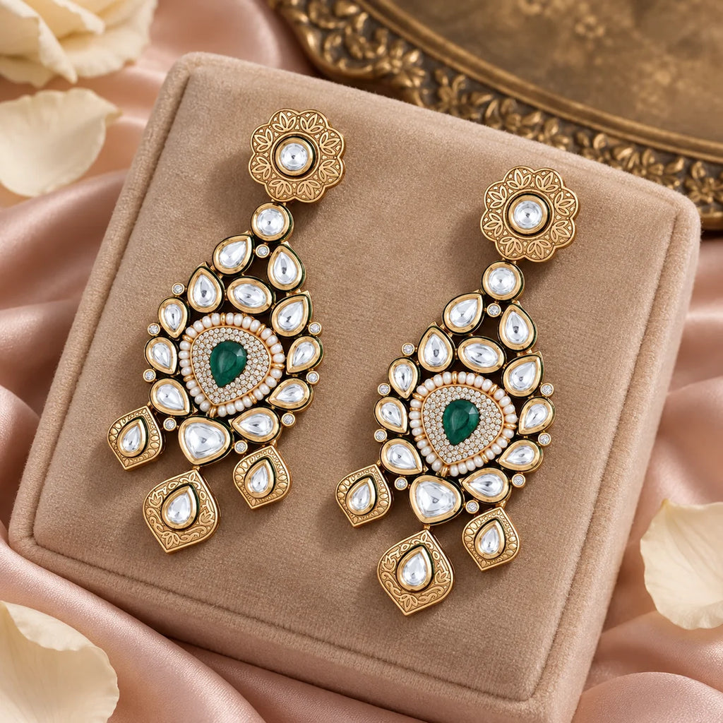 Pair of Padmika green statement earrings on a champagne velvet display with blush silk, ivory petals and a brass tray.