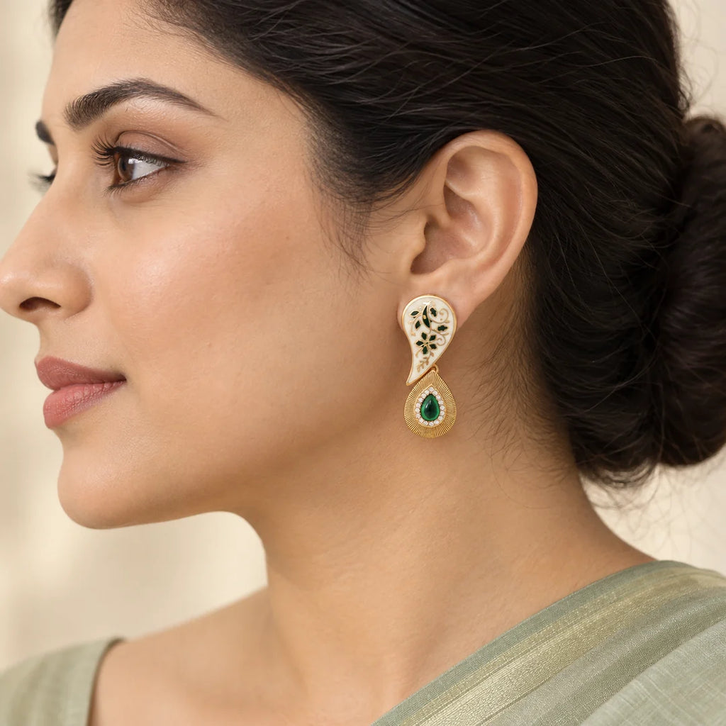 Side-profile Indian model in a sage saree wearing a Pallavi ivory and green paisley earring with a gold-tone teardrop pendant.