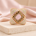 Pink and ivory Meenakari cocktail ring displayed on a luxury neutral background