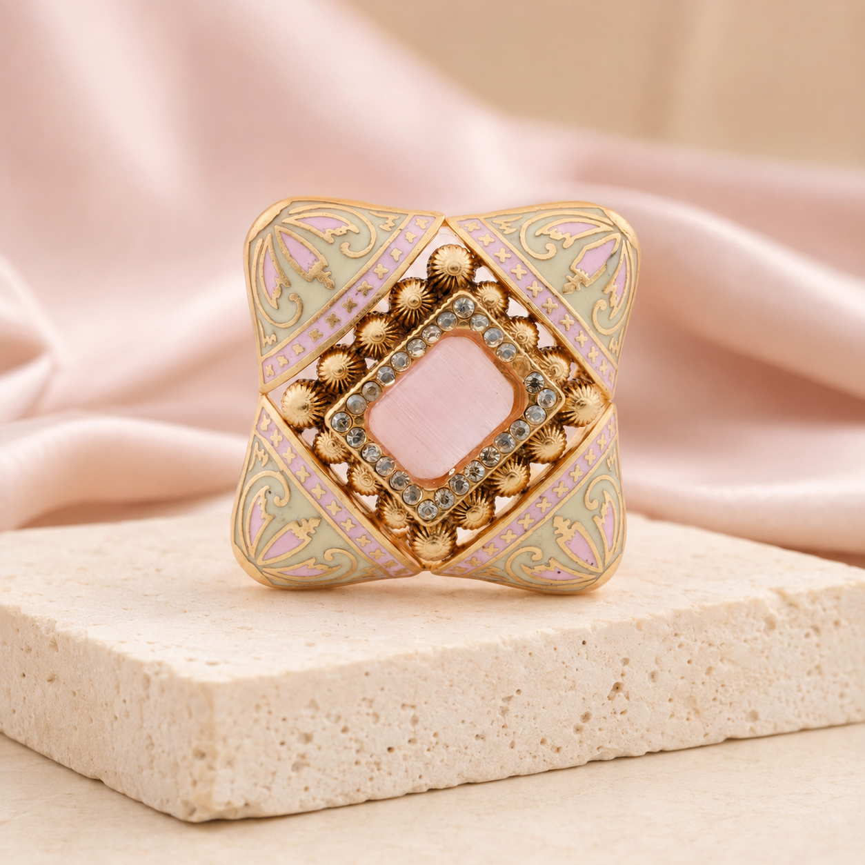 Pink and ivory Meenakari cocktail ring displayed on a luxury neutral background