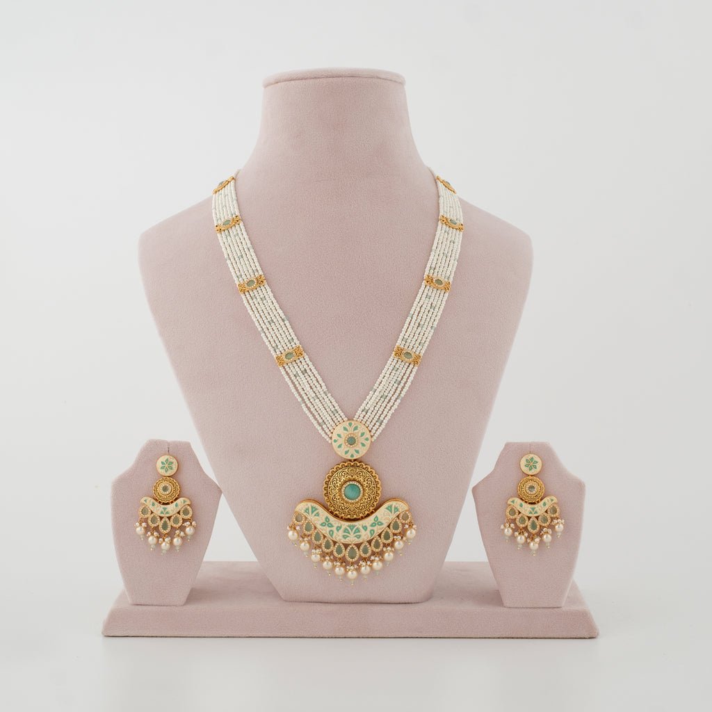 Rajvika mint artificial necklace set with ivory bead strands and matching earrings