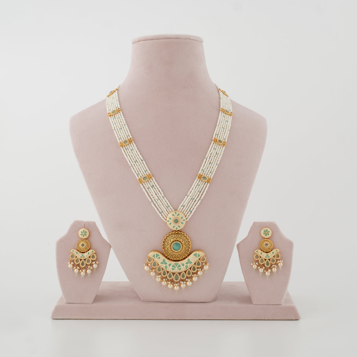 Rajvika mint artificial necklace set with ivory bead strands and matching earrings