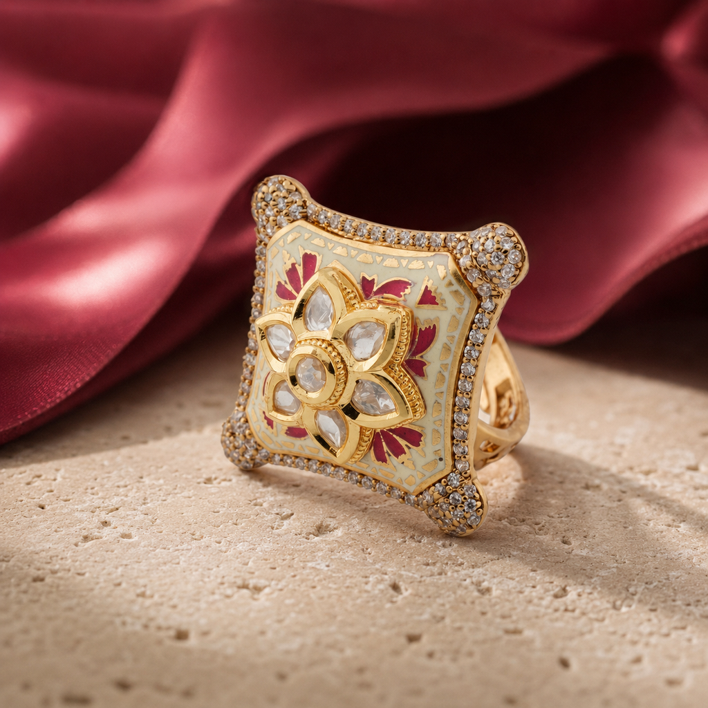 Ivory Meenakari ring with ruby-pink motifs displayed beside satin fabric