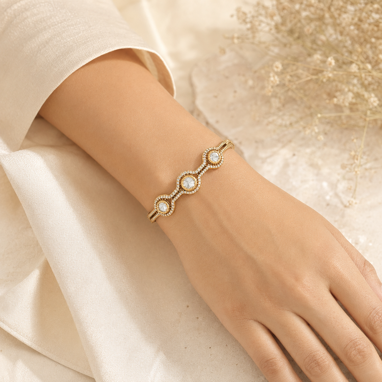 Woman wearing the Ritvi gold Polki wave bracelet naturally on her wrist