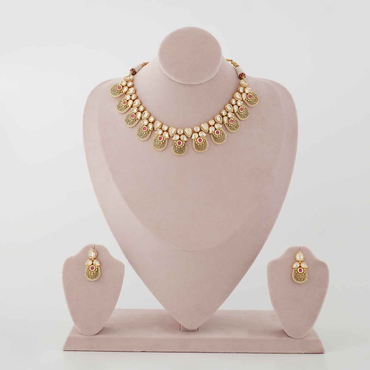 Rivanya antique gold artificial necklace set with diamond-look stones and ruby-red accents