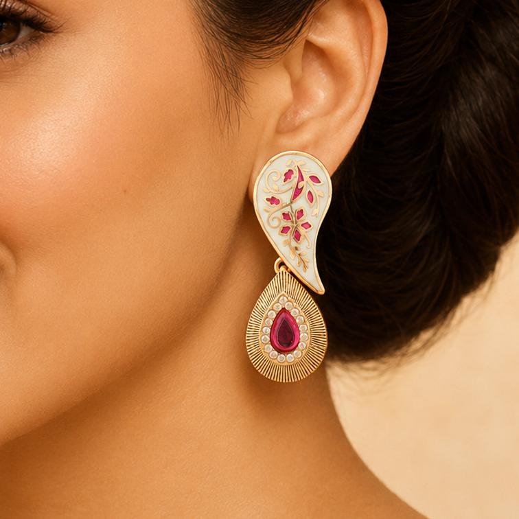 Model wearing a Ruhani ivory Meenakari paisley drop earring with a pink teardrop centre