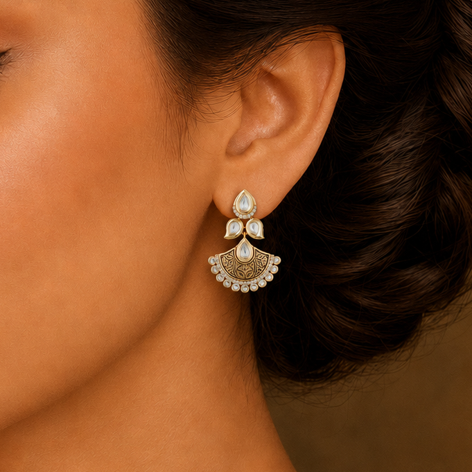 Model wearing a Saanvi antique Kundan fan earring with clear stones and engraved detailing