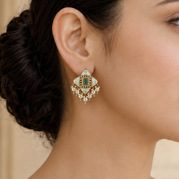 Model wearing realistically sized Samaira mint Meenakari pearl statement earrings