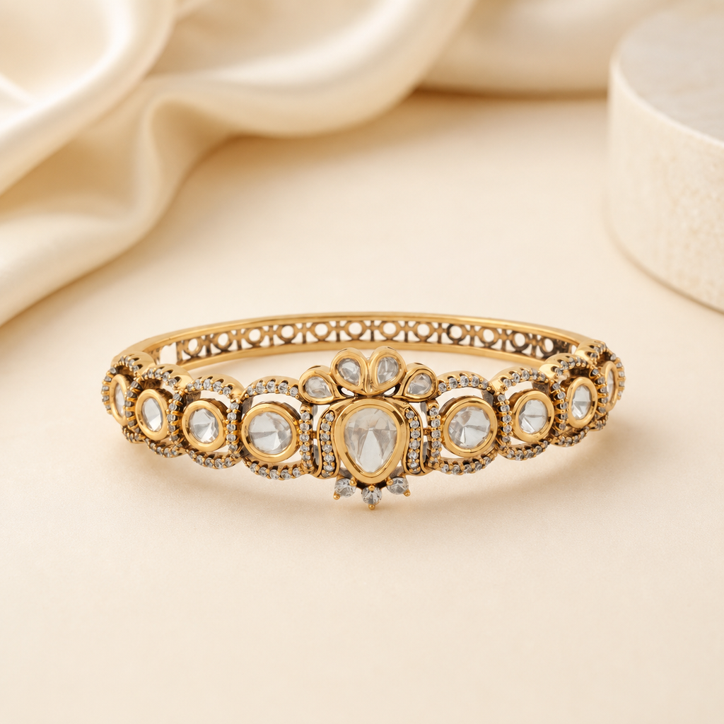 Tarini gold Polki crest bracelet displayed in a soft champagne luxury setting