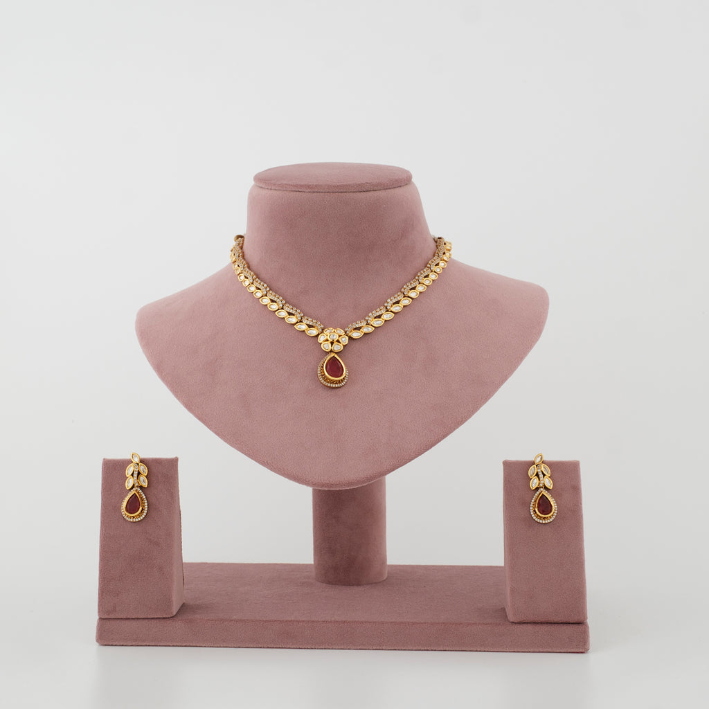 Varnika gold-tone artificial necklace set with ruby-coloured drop and matching earrings
