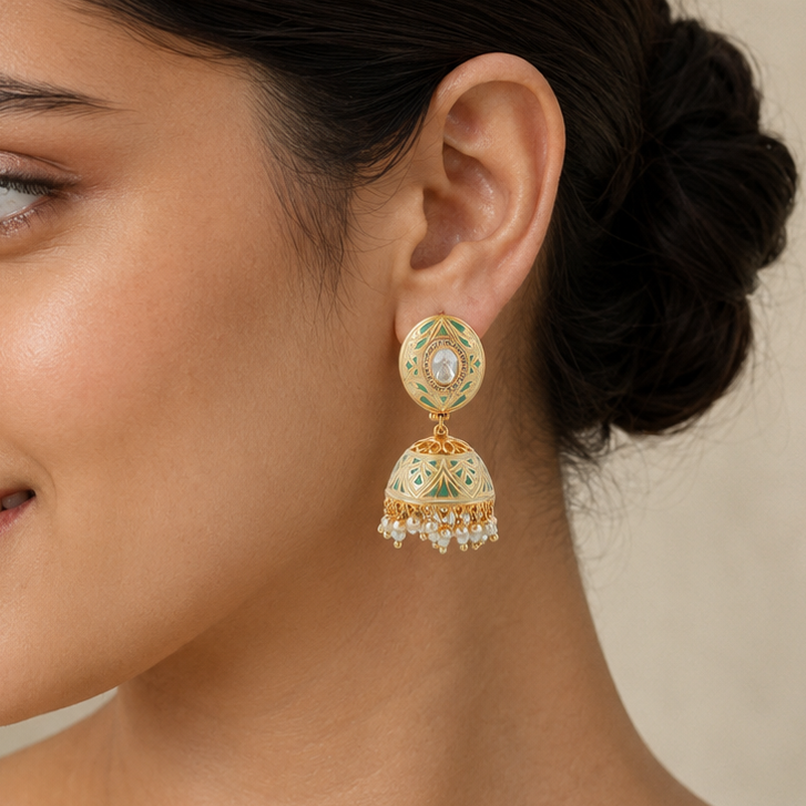 Indian model wearing Vihana mint-green meenakari pearl jhumka earring in side profile