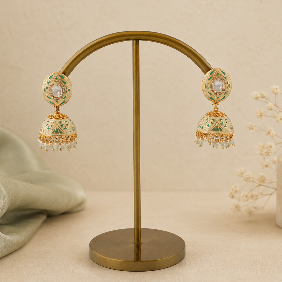 Vihana mint-green meenakari pearl jhumka earrings styled on an ivory and sage background
