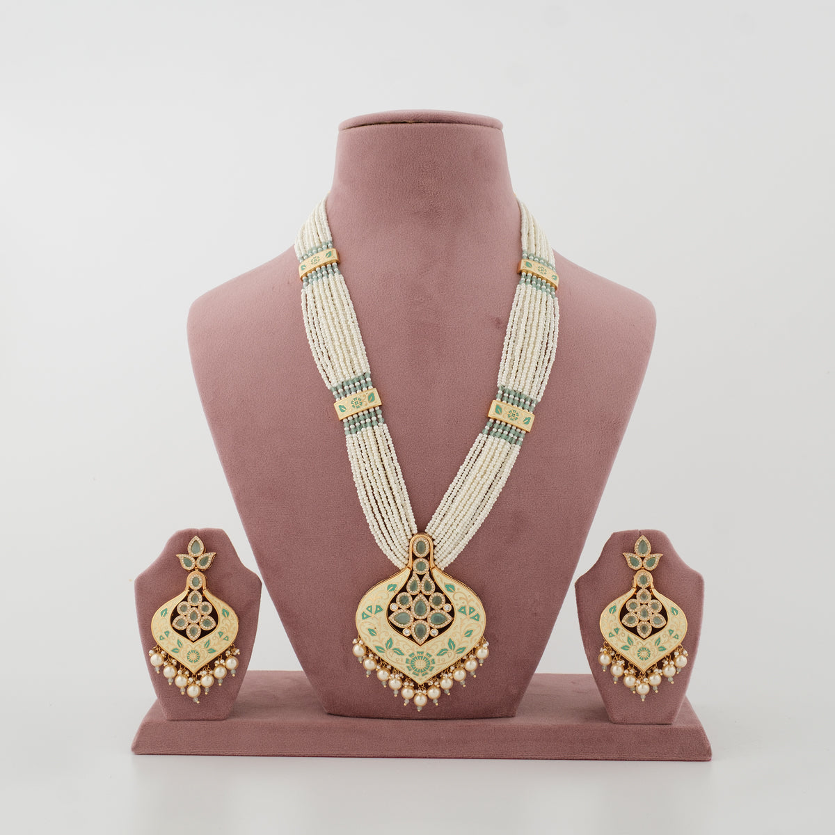 Zivanya mint artificial necklace set with ivory bead strands and matching earrings